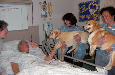 Chica and Puck visit Kindred Hospital.  Judy and Alana hold them. (3/03)